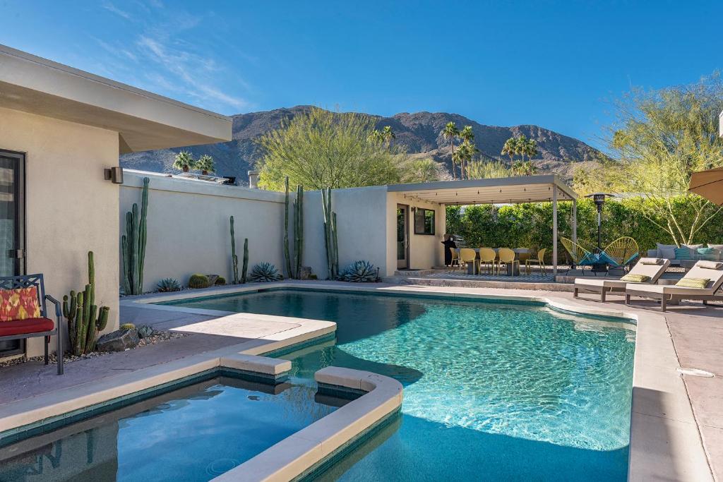 a swimming pool in the backyard of a house at The Biskra House in Rancho Mirage