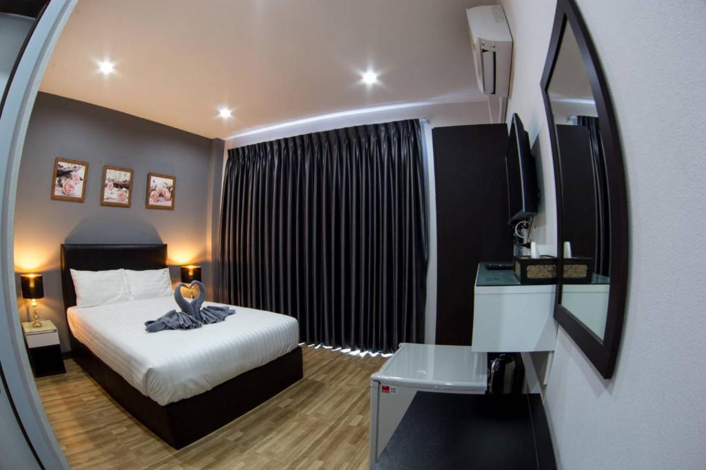 廊开Wixky hotel的一间带床和镜子的酒店房间