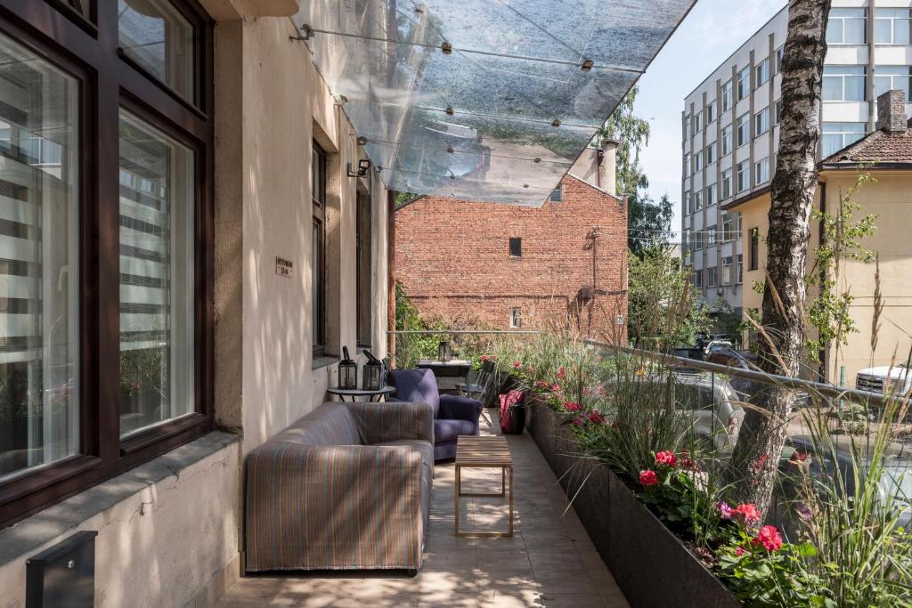 a balcony with chairs and flowers on a building at M terrace in Kaunas