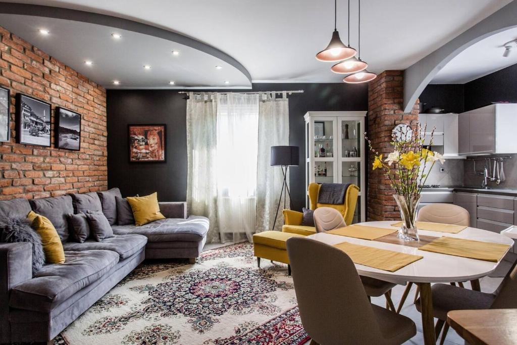 a living room with a couch and a table at Luca Holiday House in Budaörs