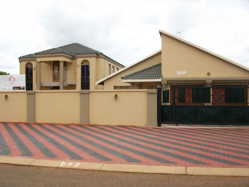 a house on a street with a garage at Koiketla Guesthouse in Pretoria