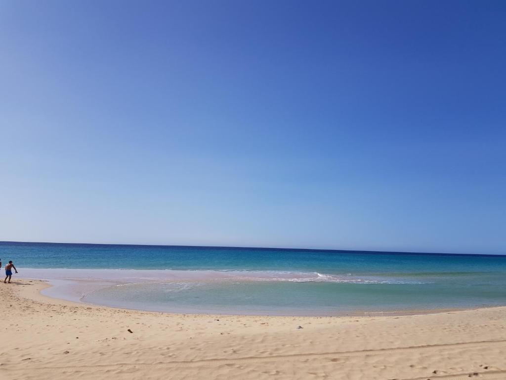 a couple of people walking on the beach at Loft del Mar 2 Jandia in Playa Jandia