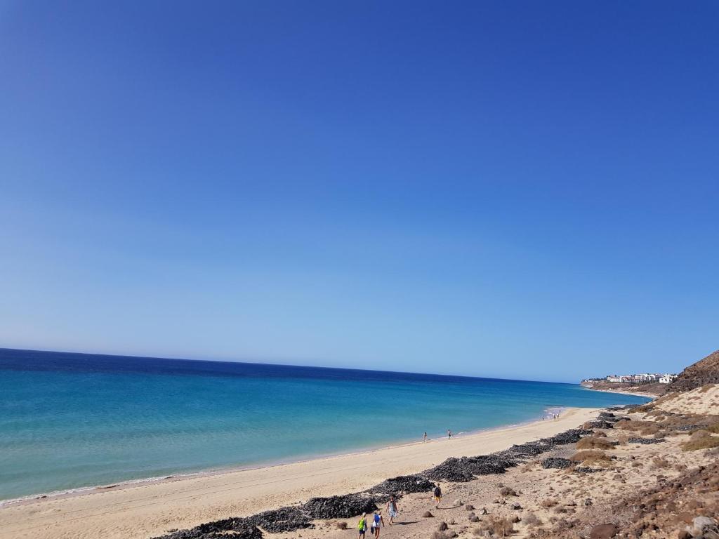 a group of people on a beach near the ocean at Loft del Mar 2 Jandia in Playa Jandia