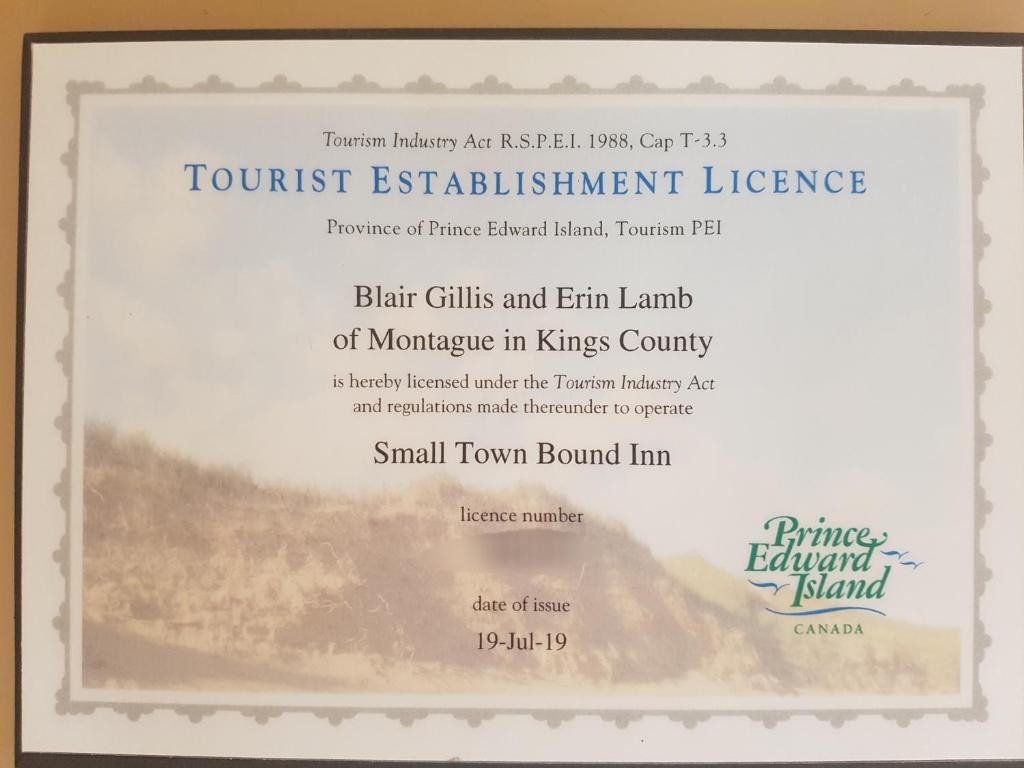 a diploma frame with a picture of the foresteasteast instrument license at Small Town Bound Inn in Montague