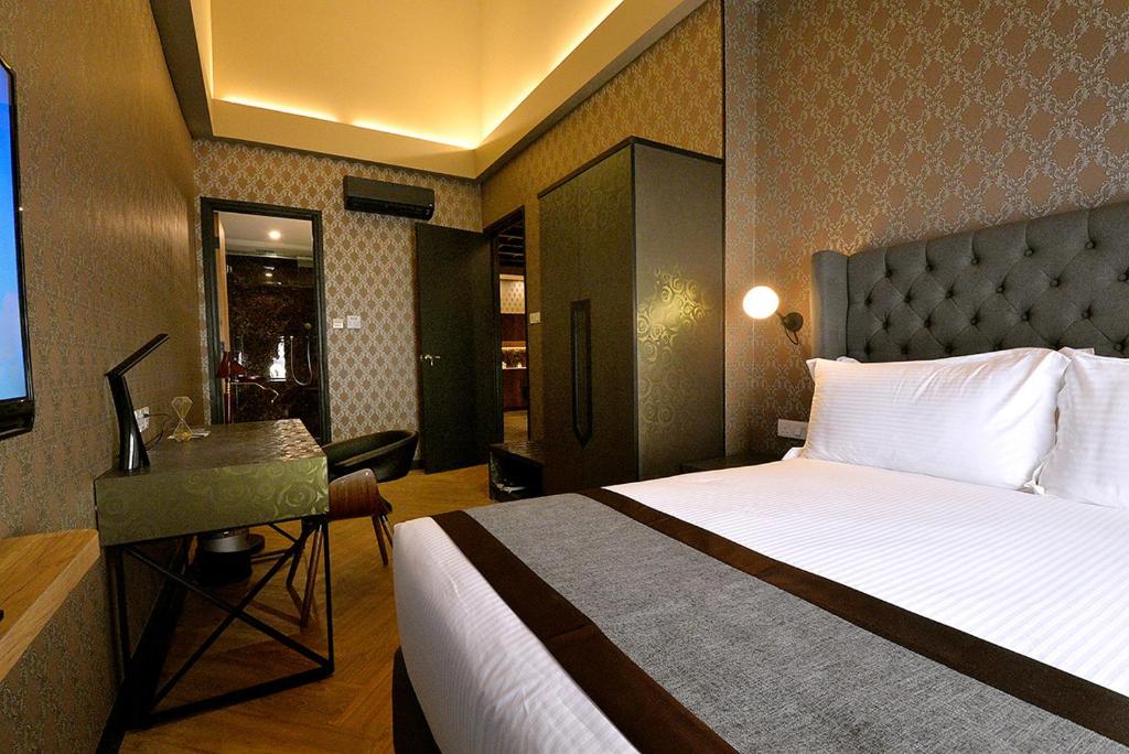 Postel nebo postele na pokoji v ubytování 1969 Business Suites Bandar Botani, Ipoh