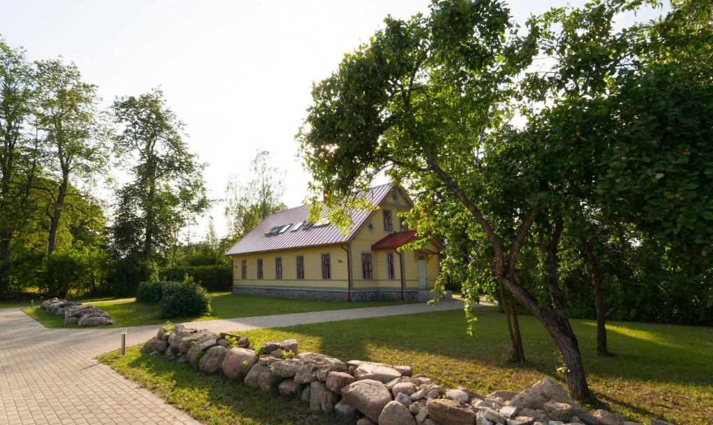 a house with a stone wall in front of it at Majesi Apartments in Märjamaa