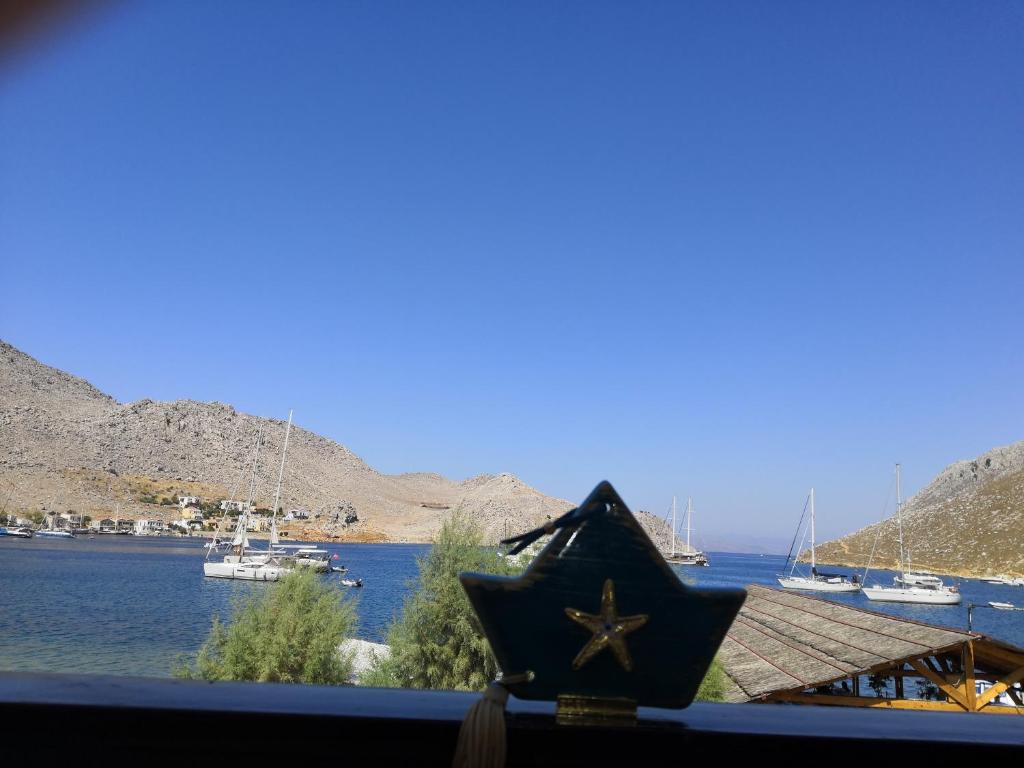 a star on a window with a view of the water at Korali in Symi