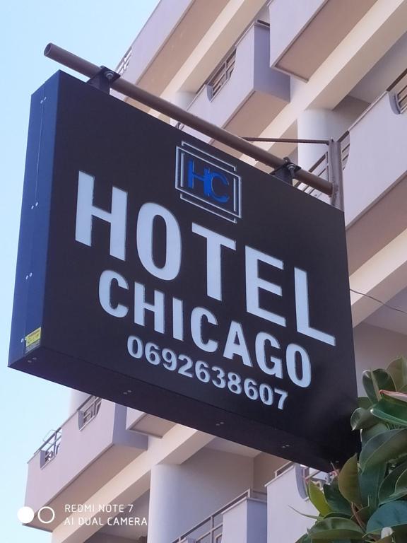 a sign for a hotel chicago on the side of a building at Hotel Chicago in Sarandë