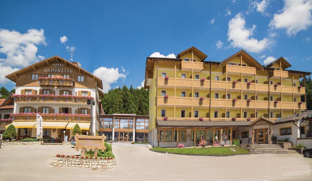 a large hotel in a town with buildings at Caminetto Mountain Resort in Lavarone