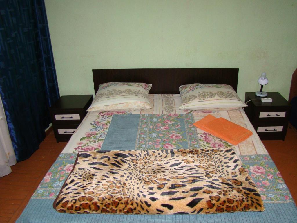 a bed with a leopard print blanket on it at Home Hotel Novoslobodskaya in Moscow