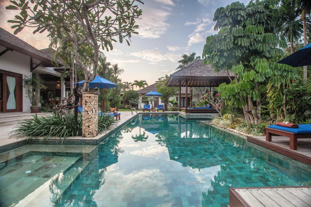 a swimming pool in a villa with a resort at Baan Pinya Balinese Style Pool Villa in Krabi town