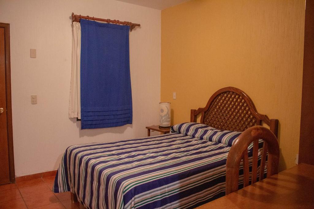 Postel nebo postele na pokoji v ubytování Hotel Degollado