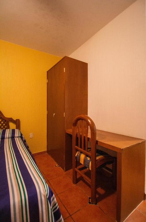 Postel nebo postele na pokoji v ubytování Hotel Degollado
