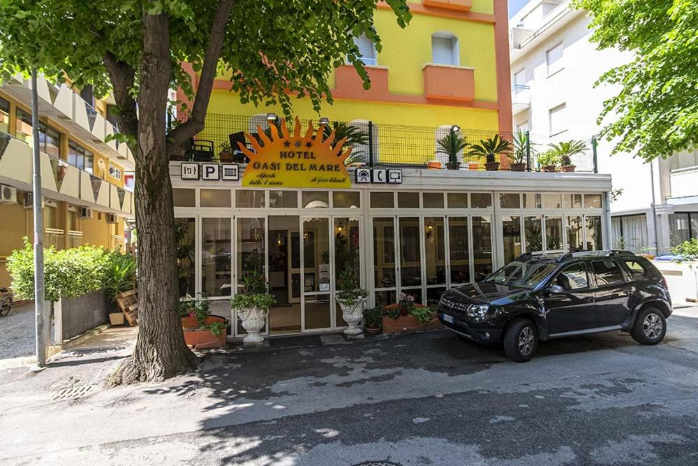 a car parked in front of a building at Hotel Oasi del Mare in Rimini