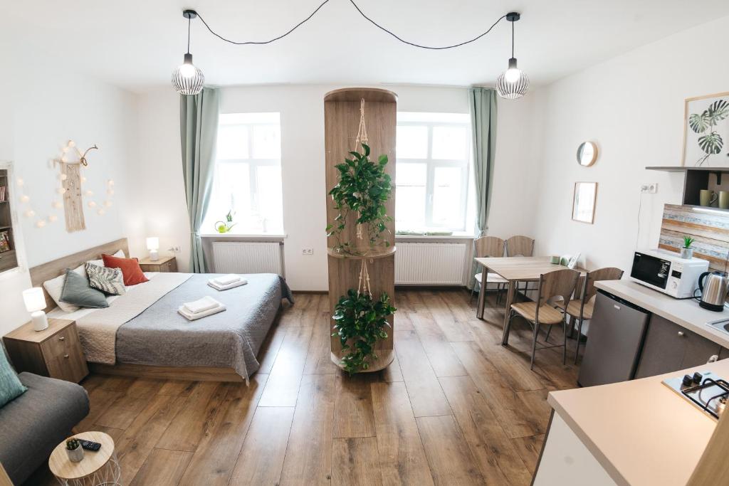 a small living room with a bed and a table at "Green Oasis Apartment" in Lviv