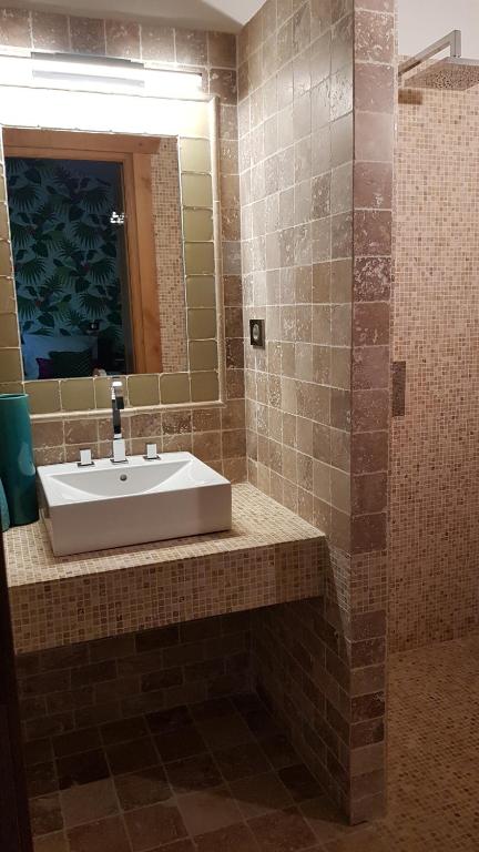 a bathroom with a sink and a mirror at Maison d hotes Lapitxuri in Arcangues