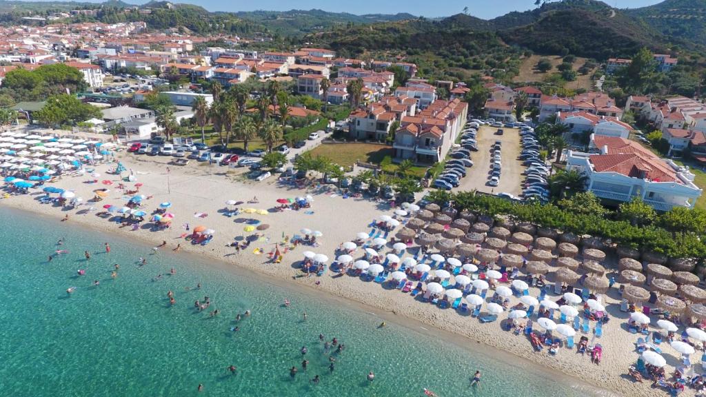 an aerial view of a beach with people and umbrellas at Villa The View - Beachfront, 5 Bedrooms, BBQ, View in Pefkohori