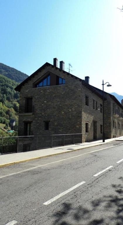 a brick building on the side of a road at Apartamentos Solans in Bielsa