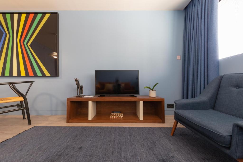 Télévision ou salle de divertissement dans l'établissement BessaApartments