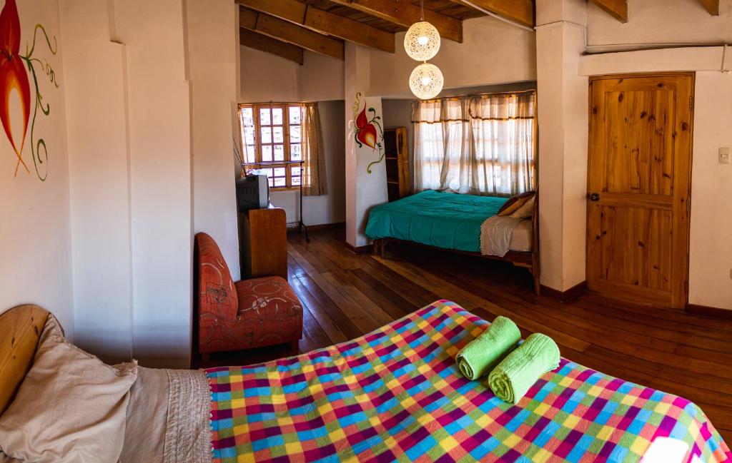 a living room with a couch and a bed in a room at Villa Betty B&B in Cusco