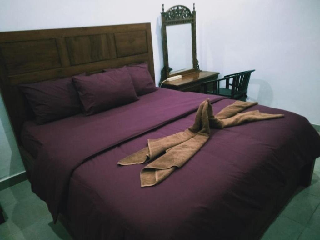 En eller flere senge i et værelse på Belongs Beach Bungalow