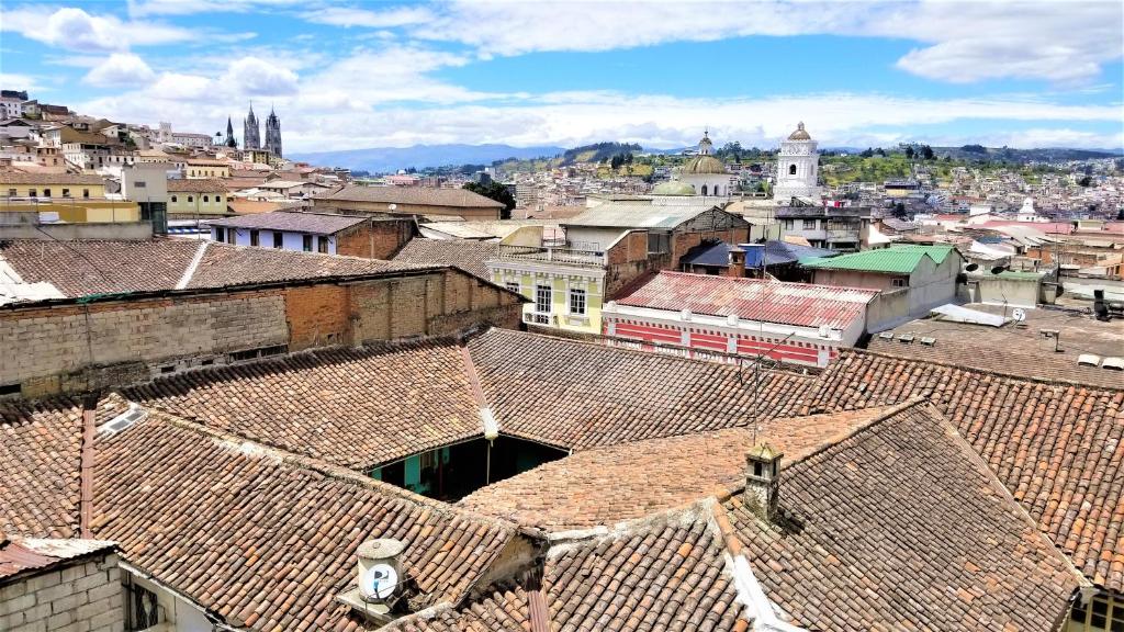 an overhead view of a city with roofs at LA CASA DEL CENTRO in Quito