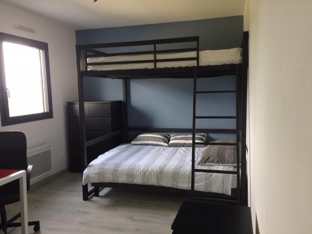 a bedroom with two bunk beds in a room at Villa avec piscine privée, vue sur mer et plage à pied 800m in Saint-Jean-de-Luz