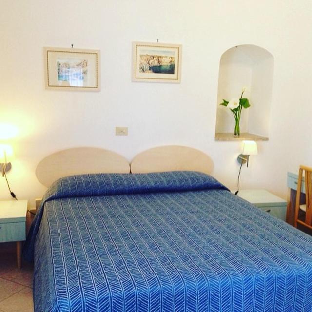 Postel nebo postele na pokoji v ubytování Hotel Isolabella