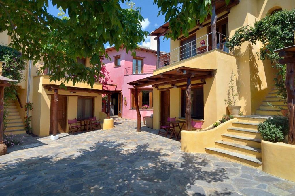 a street in a town with a pink building at Alkifron Hotel in Kala Nera