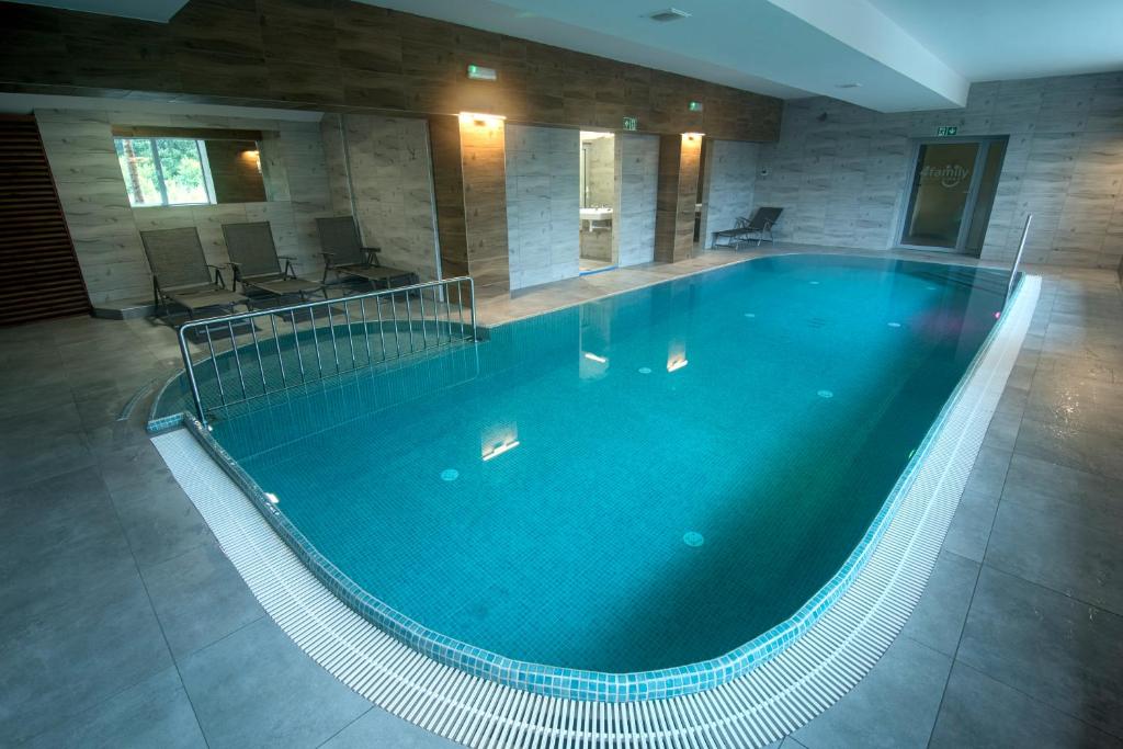 a large swimming pool in a large building at 4family *RESORT*SPA* in Szklarska Poręba