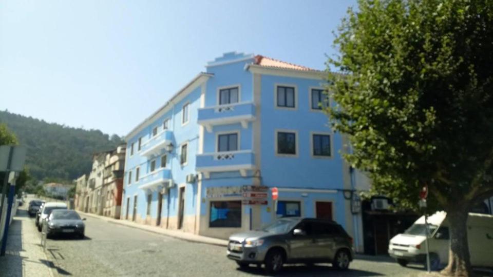 a blue building on the side of a street at Hotel Bem Estar in Lousã