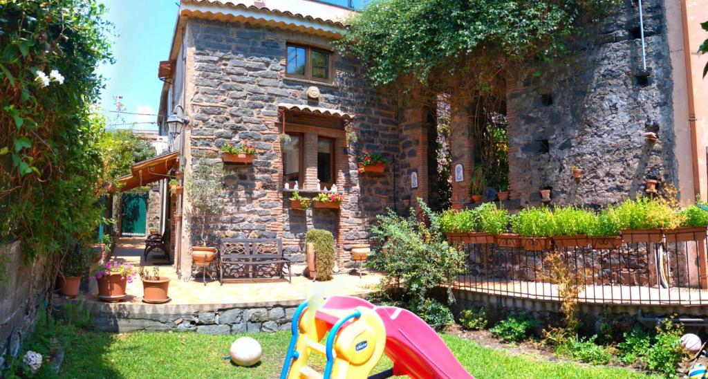 a house with a yard with a toy in front of it at NICE mini House - tra l'Etna Catania Taormina e il Mare in Trecastagni