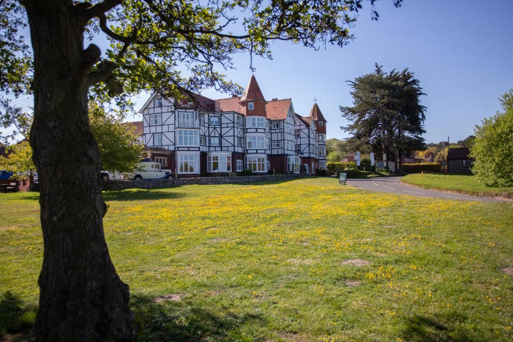 a large house with a tree in front of it at Links Country Park Hotel in Cromer