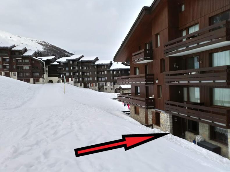 a red arrow in the snow next to a building at HSL in Valmorel