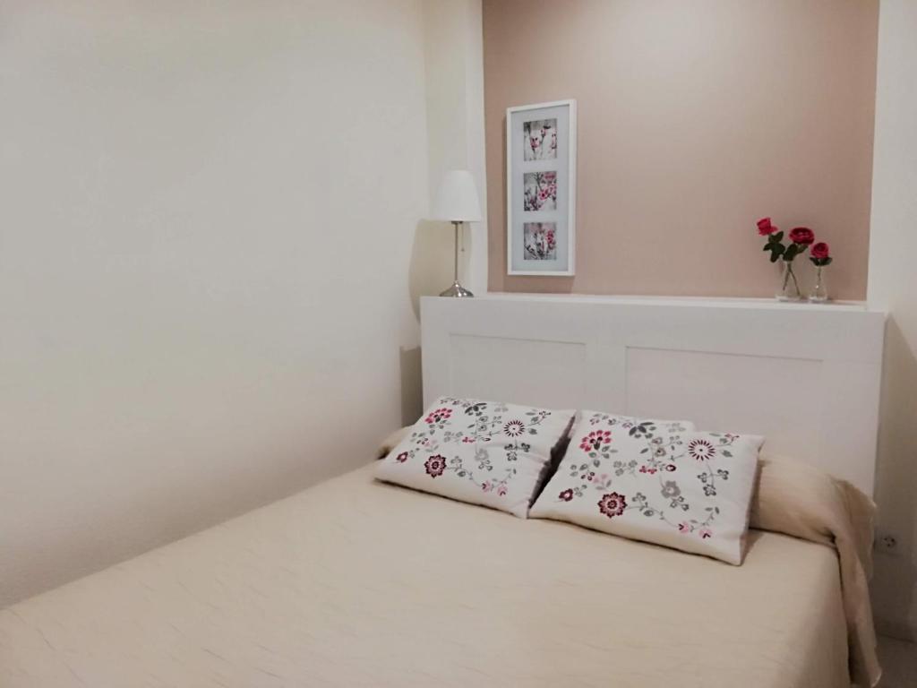 a white bed with two pillows on top of it at Brisa del Teide - Free parking in Playa Paraiso