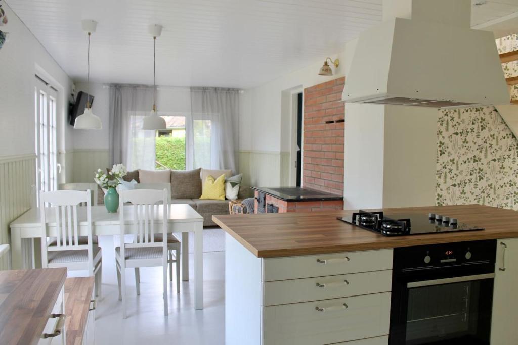 a kitchen and living room with a table and chairs at Villa Orissaare in Orissaare