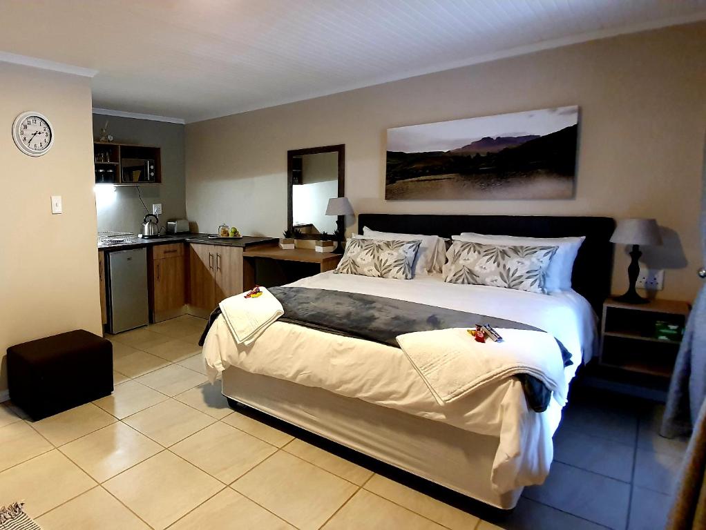 a bedroom with a large bed and a kitchen at Dream Hills in Hillcrest