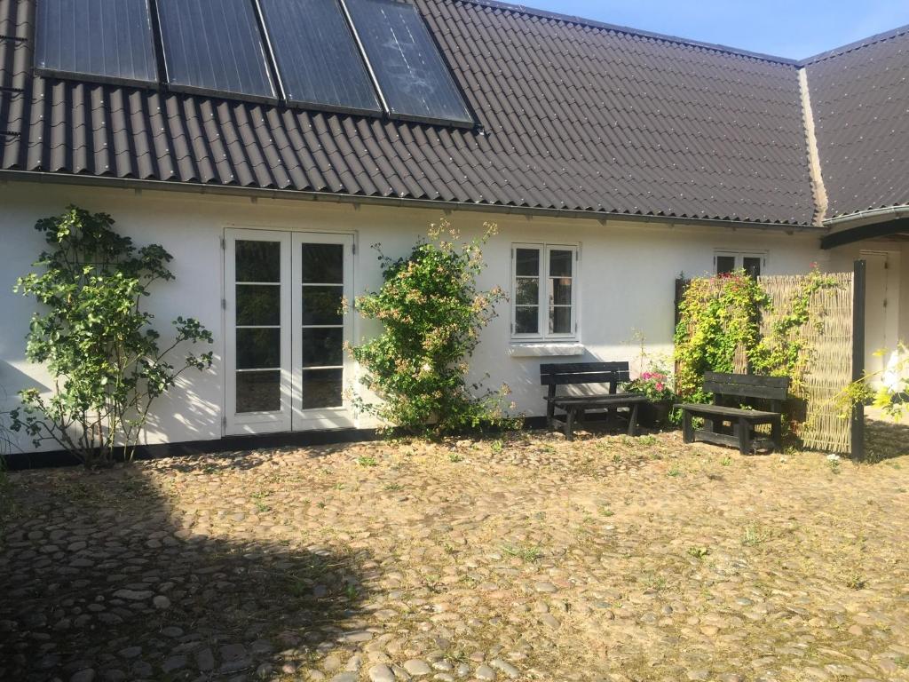 a house with solar panels on the side of it at Happy Hill Farm in Gilleleje