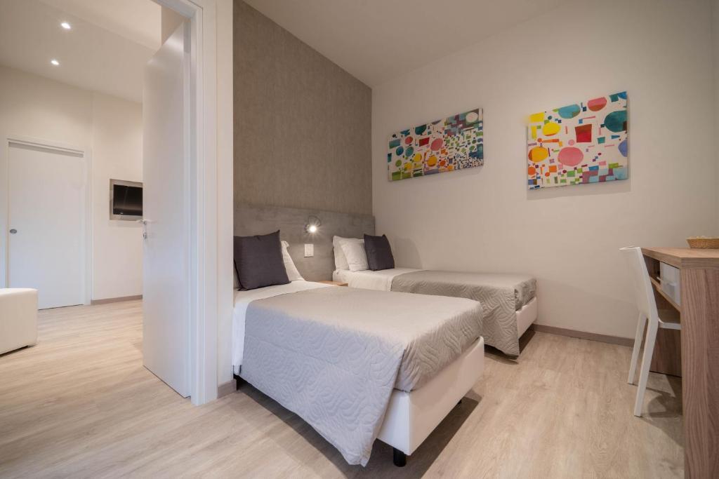 Postel nebo postele na pokoji v ubytování Hotel Reggiana