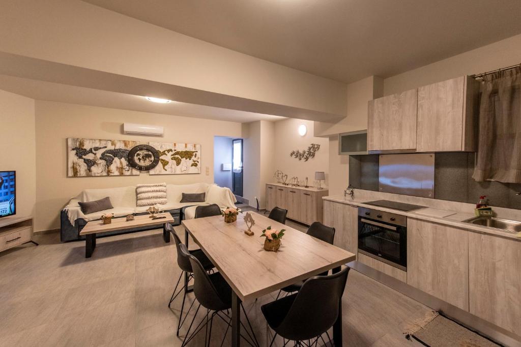 een keuken en een woonkamer met een tafel en een bank bij Theo and MS Luxurious Apartments in Kos-stad
