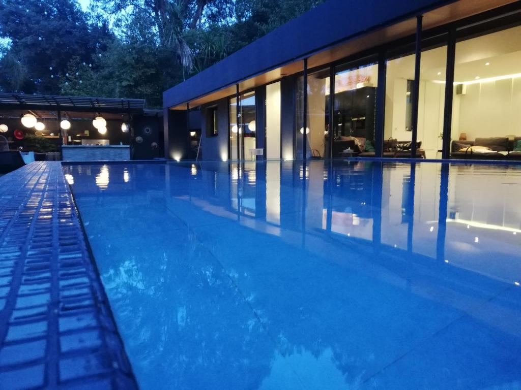 a swimming pool in front of a house at Villa Le Ruisseau in Cannes