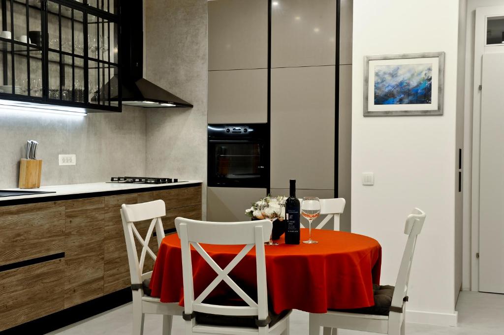 a kitchen with a table with a red table cloth at ANiMA Zagreb Luxury Apartment in Zagreb