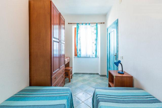 A bed or beds in a room at On The Beach La Rena Beddha