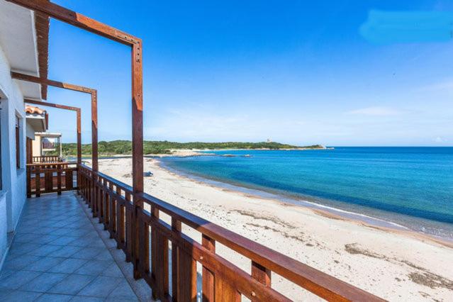 a balcony of a house with a view of the beach at On The Beach La Rena Beddha in Aglientu