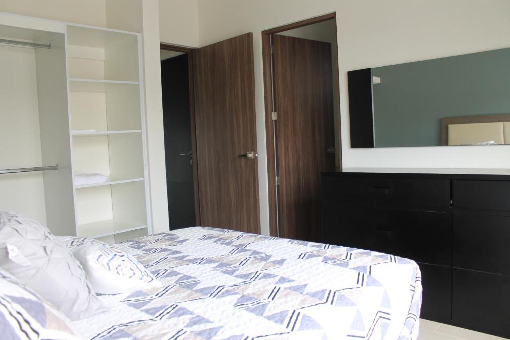 a bedroom with a bed and a large mirror at Suits Murato in San Luis Potosí
