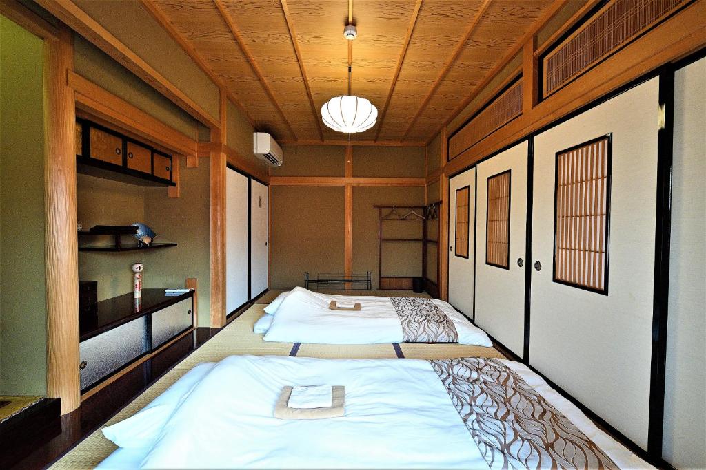 Postel nebo postele na pokoji v ubytování Hida-Takayama Michi