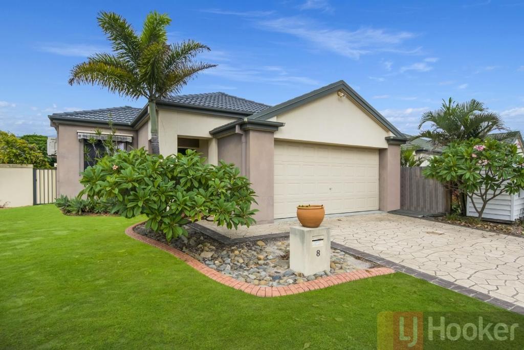 a house with a palm tree in a yard at Oceania Beach Paradise LJHooker Yamba in Yamba