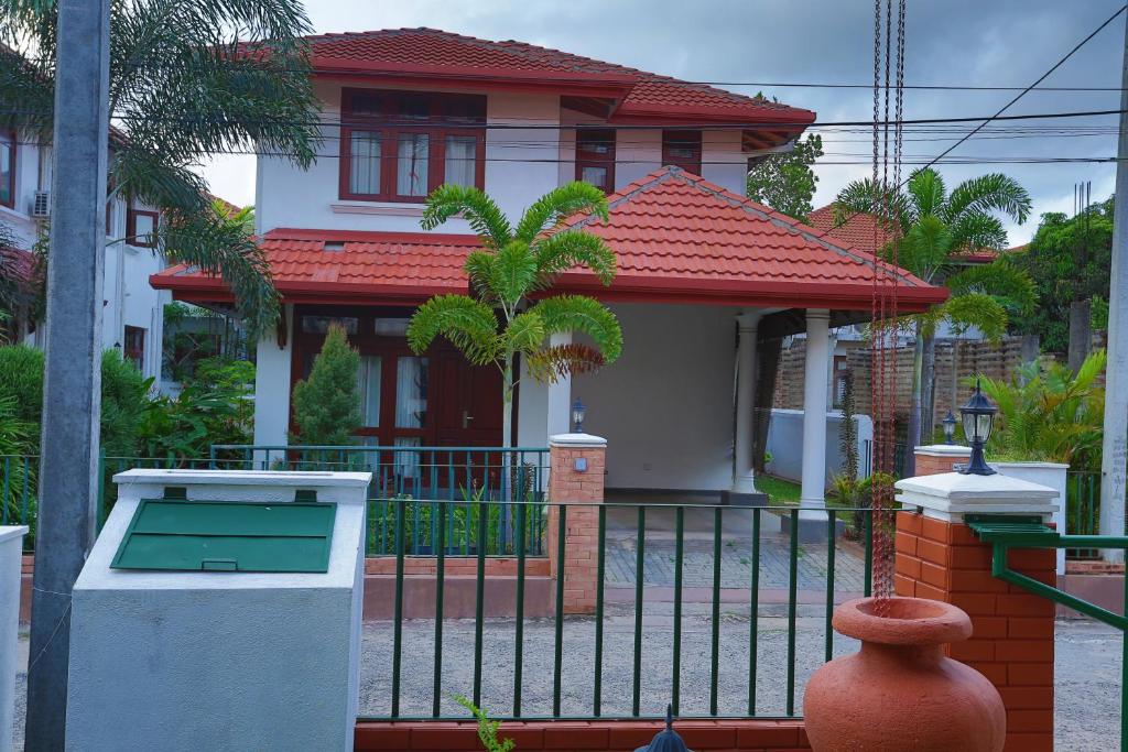a house with a gate in front of it at Villa Agoura Grand Negombo in Negombo