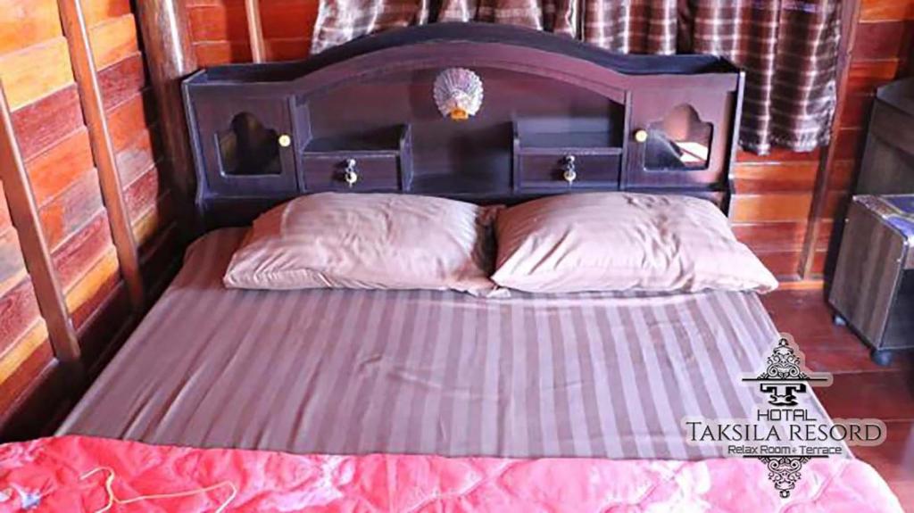 Postel nebo postele na pokoji v ubytování Taksila Resort ฏักร์ศิลารีสอร์ท