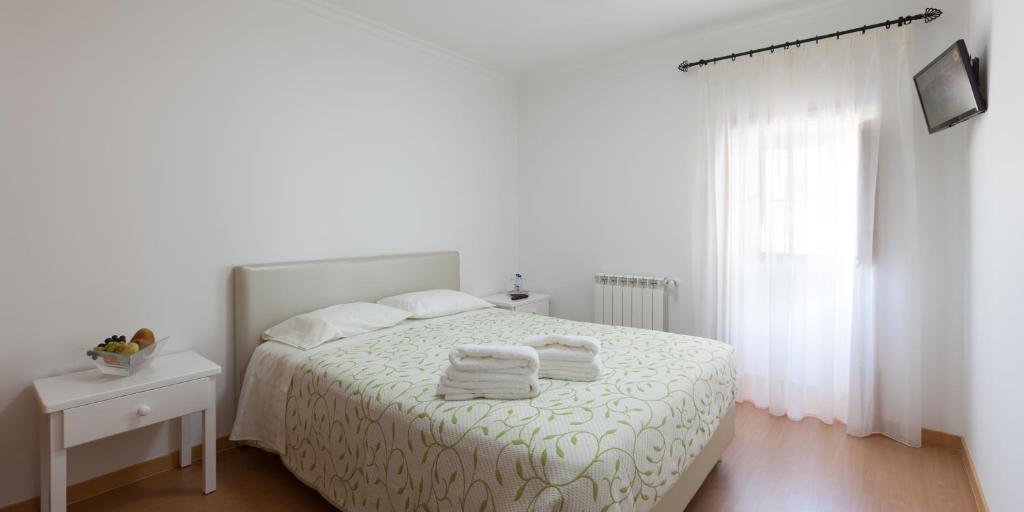 Postel nebo postele na pokoji v ubytování Casa dos Tios